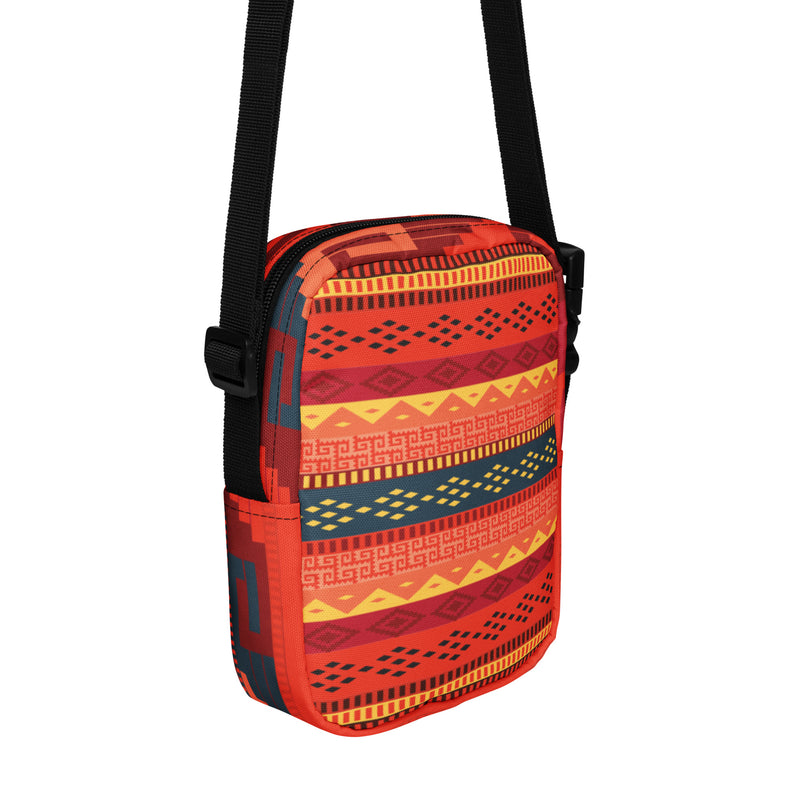 Bolso bandolera utilitario en tonos rojos con grecas zapotecas