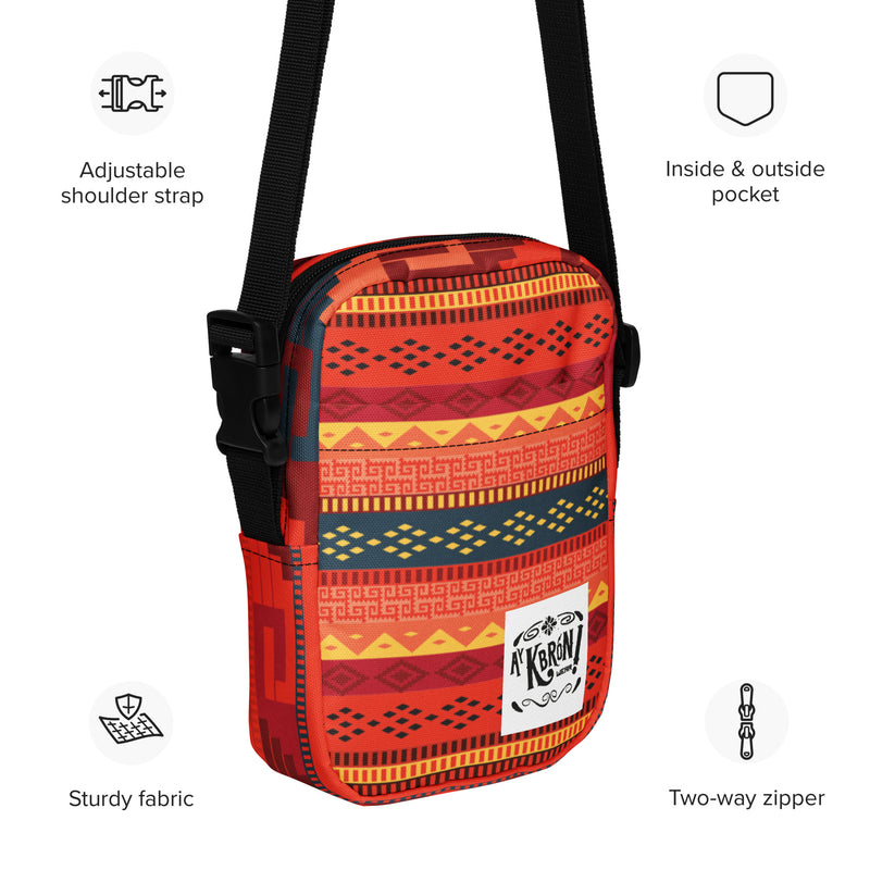 Bolso bandolera utilitario en tonos rojos con grecas zapotecas